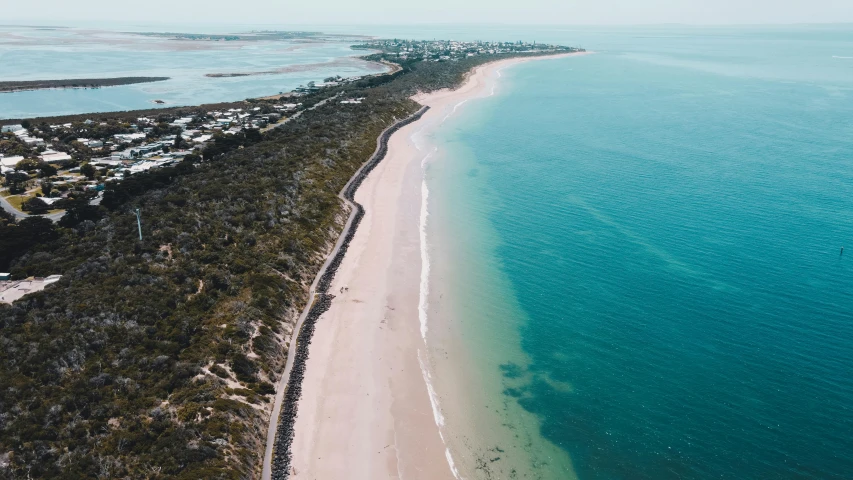 an aerial view of a beach in the middle of the ocean, by Lee Loughridge, unsplash contest winner, “ iron bark, long view, beachfront, looking to the right