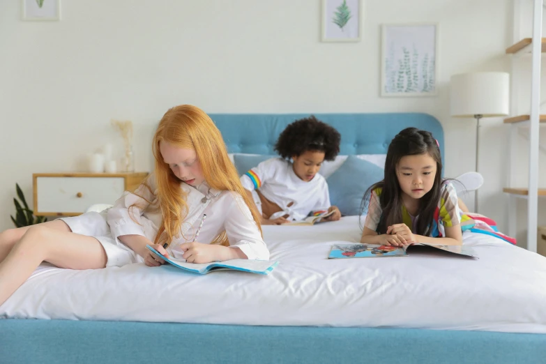 three girls sitting on a bed reading books, a child's drawing, penned in cyan ink, white sketchbook style, un made bed, medium close up shot