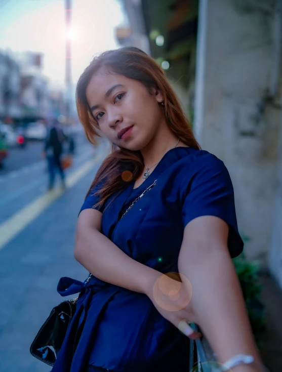 a woman standing on the side of a street, by Robbie Trevino, wearing a dark blue polo shirt, full frame image, joy ang, low quality photo