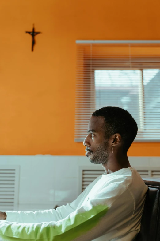 a man sitting on a couch using a laptop computer, an album cover, by Washington Allston, pexels contest winner, looking off to the side, lofi portrait at a window, sitting in the classroom, malcolm hart