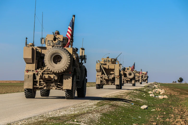 a group of military vehicles driving down a road, 🦩🪐🐞👩🏻🦳, getty images, islamic, usa