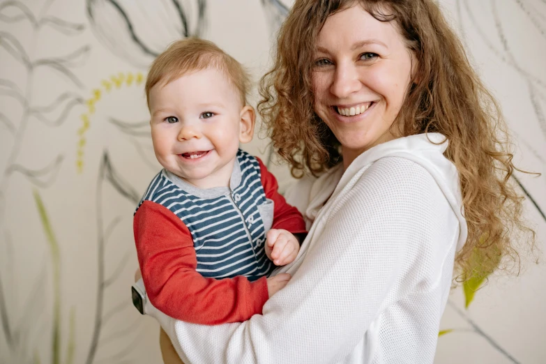 a woman holding a baby in her arms, pexels contest winner, happening, both smiling for the camera, avatar image, bedhead, carefully designed