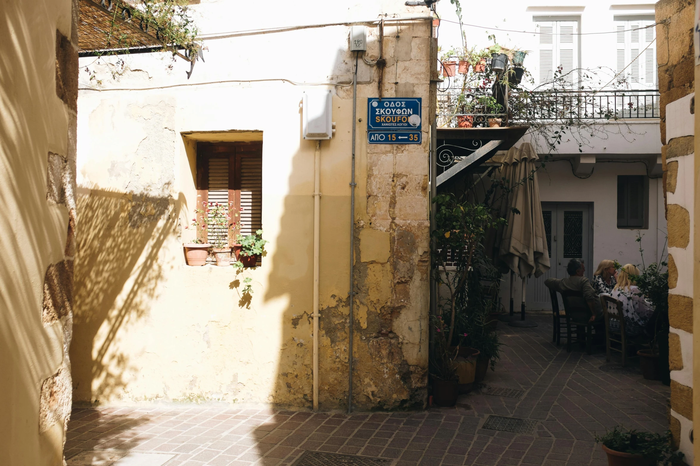 a couple of buildings that are next to each other, pexels contest winner, les nabis, shady alleys, greek nose, sunfaded, light coming from the entrance