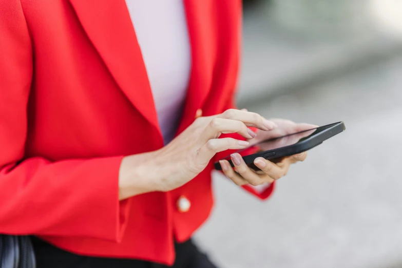 a woman in a red jacket holding a cell phone, trending on pexels, royal commission, corporate phone app icon, red tailcoat, messages