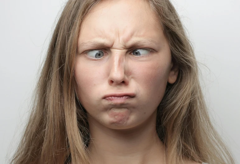 a woman with a surprised look on her face, by Lasar Segall, trending on pexels, angry looking at camera, portrait of white teenage girl, scientific photo, close - up studio photo