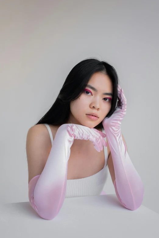 a woman with long black hair wearing pink gloves, inspired by Yanjun Cheng, trending on pexels, wearing white silk, reflective skin, gradients and soft light, wearing latex