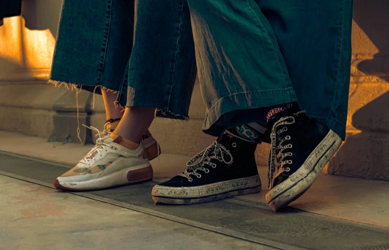 a couple of people sitting next to each other, by Elsa Bleda, unsplash, graffiti, sneaker shoes, acid wash layering, 7 0 s style, made with photoshop