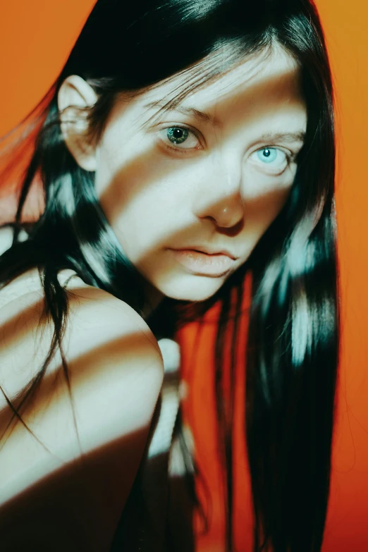 a close up of a person with long hair, an album cover, inspired by Elsa Bleda, trending on pexels, hyperrealism, bright orange eyes, aurora aksnes, indoor picture, light blue eyes