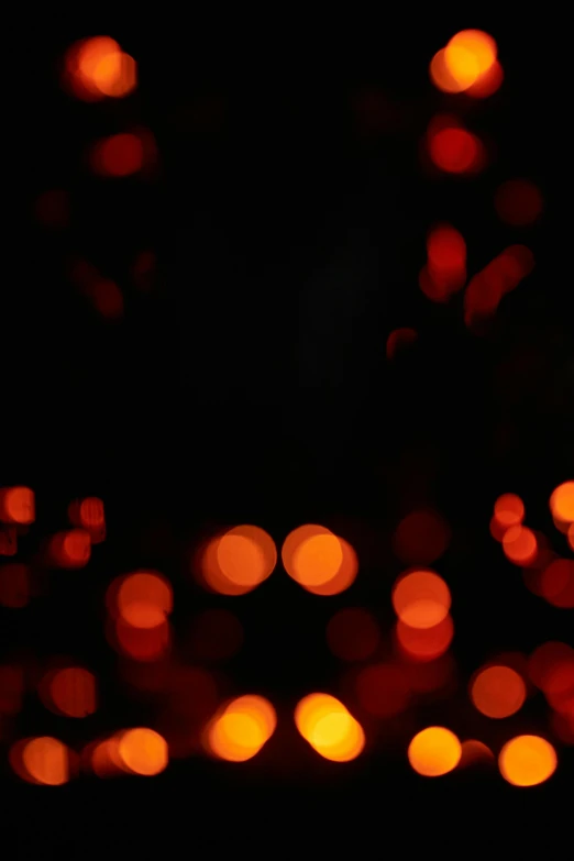 a candle that is lit up in the dark, an album cover, by Attila Meszlenyi, reddit, dots abstract, bokeh!!, dark oranges reds and yellows, light reflection