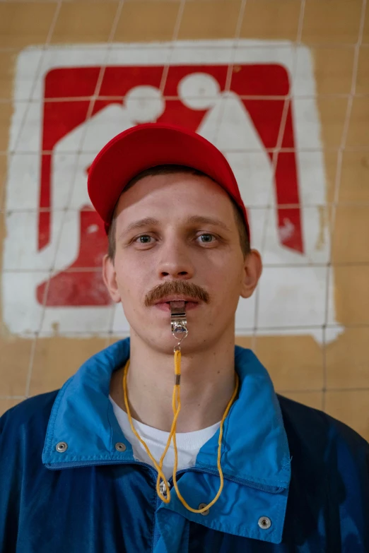 a man with a mustache standing in front of a sign, an album cover, by Attila Meszlenyi, dribble, graffiti, wearing a red backwards cap, huge earrings and queer make up, russian academic, headshot profile picture