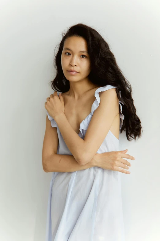 a woman in a blue dress posing for a picture, wearing white camisole, bedhead, asian descent, hila klein