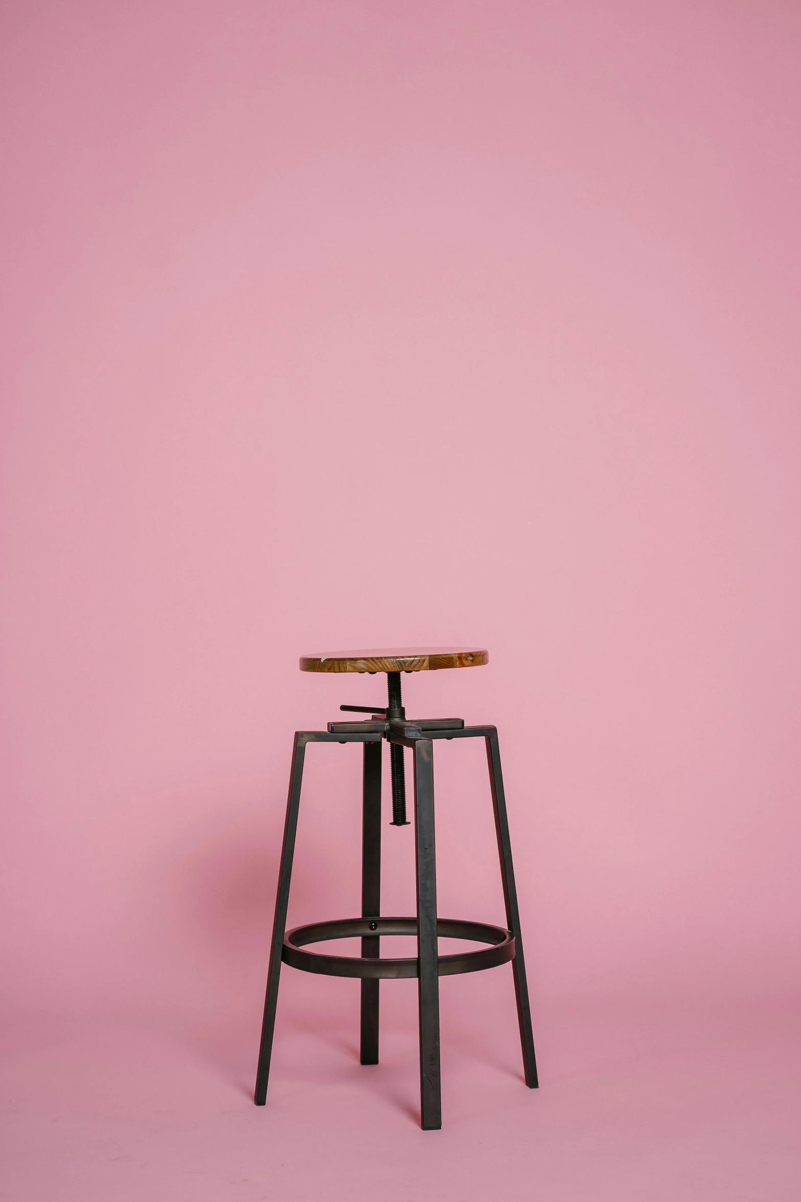 a wooden stool against a pink wall, trending on unsplash, hero shot, blank background, multiple stories, 15081959 21121991 01012000 4k