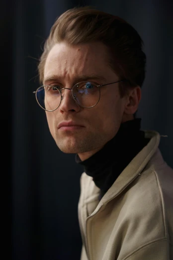 a close up of a person wearing glasses, a character portrait, inspired by Oskar Lüthy, trending on reddit, wearing a turtleneck and jacket, stony, he is wearing a trenchcoat, ( ( theatrical ) )
