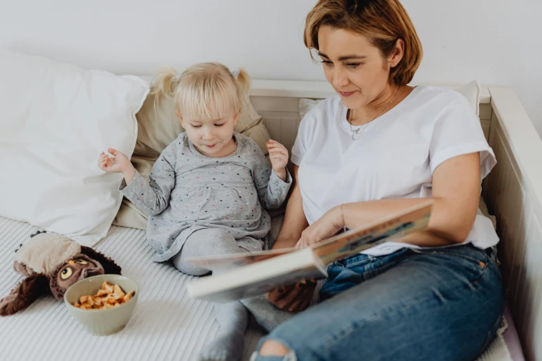 a woman reading a book to a child on a bed, pexels contest winner, casually dressed, avatar image, high resolution photo, portrait image