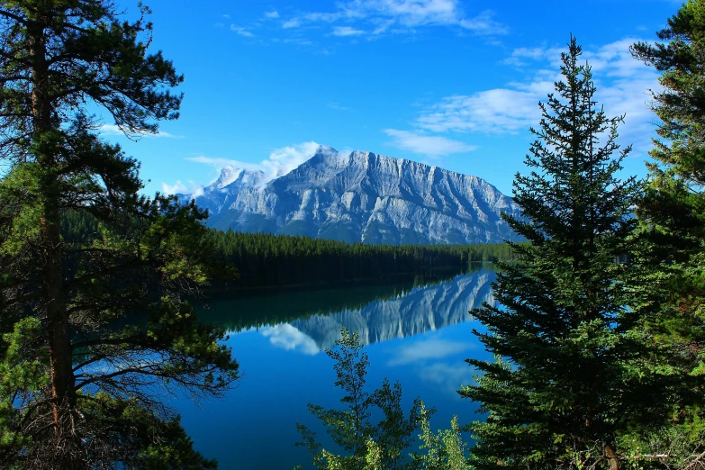 a large body of water surrounded by trees, by Alexander Johnston, pexels contest winner, banff national park, avatar image, two mountains in background, high definition photo