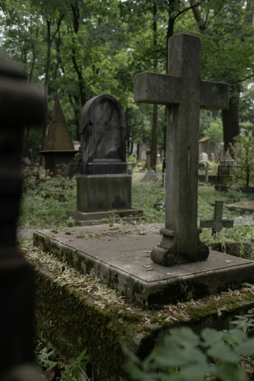 a cemetery filled with lots of tombstones and trees, a statue, by Attila Meszlenyi, unsplash, movie filmstill, orthodox, ( ( theatrical ) ), parce sepulto
