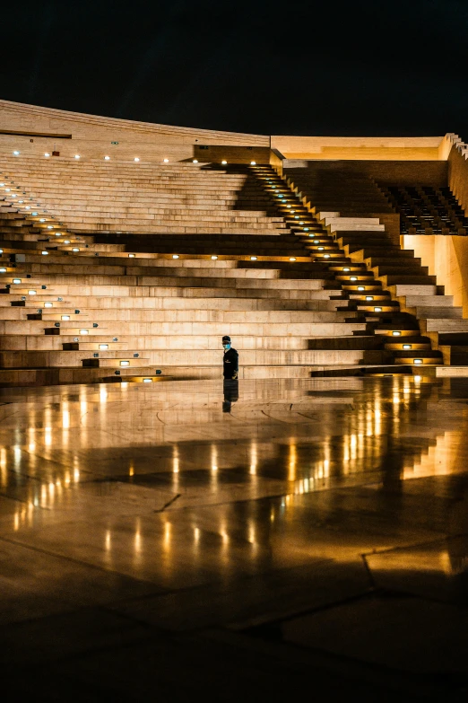 a man standing in front of an empty stadium, by Ibrahim Kodra, pexels contest winner, minimalism, singing at a opera house, candlelit, steps, israel