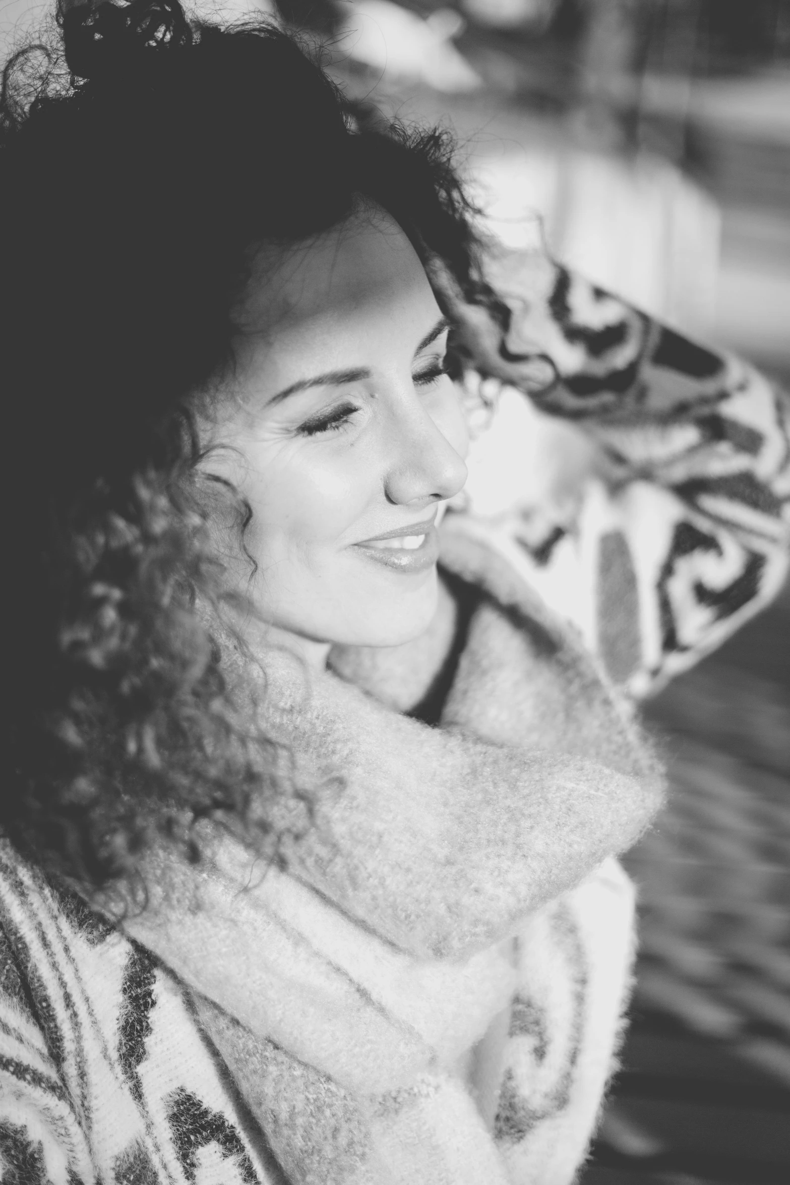 a black and white photo of a woman with curly hair, a black and white photo, inspired by Anita Malfatti, pexels contest winner, happening, warm coloured, wearing gorgeous clothing, cosy, smiling :: attractive