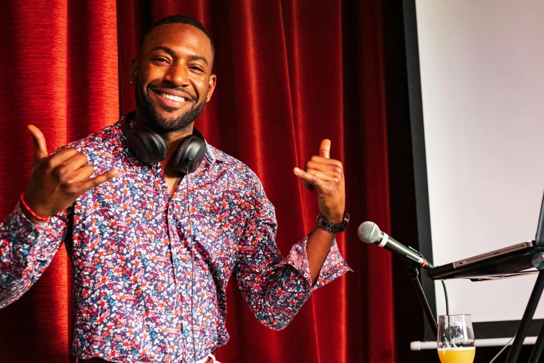 a man with headphones standing in front of a microphone, by Amos Ferguson, earing a shirt laughing, mkbhd, patterned, thumbnail