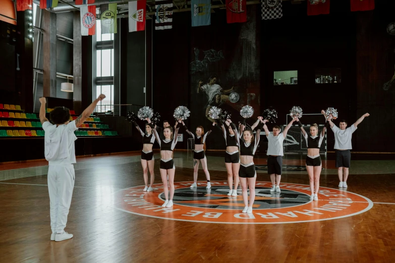 a group of young women standing on top of a basketball court, by Emma Andijewska, pexels contest winner, hurufiyya, knight in armor dance popping, orange and white color scheme, indoor setting, daddy energy