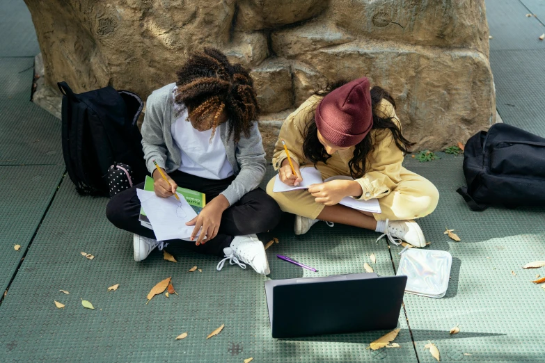 two girls sitting next to each other on the ground, trending on pexels, academic art, writing on a clipboard, essence, school courtyard, computer science