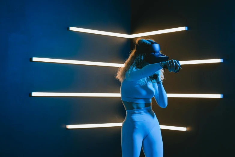 a woman in a blue outfit holding a baseball bat, a hologram, pexels contest winner, interactive art, vr helmet, physical : tinyest midriff ever, vantablack wall, aesthetic lighting