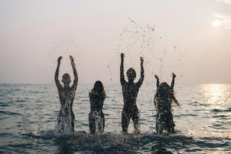 a group of people standing on top of a body of water, profile image, girls, splashing, top selection on unsplash