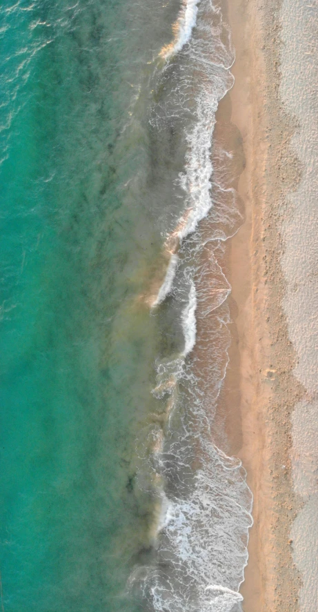 a person riding a surfboard on top of a sandy beach, arial shot, orange and teal color, seafloor, photo 8 k