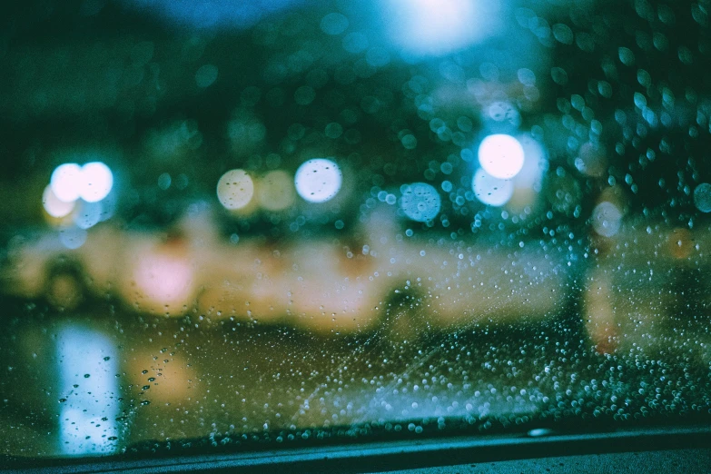 a close up of a window with rain on it, inspired by Elsa Bleda, unsplash, visual art, outside in parking lot, teal lights, thumbnail, chillhop