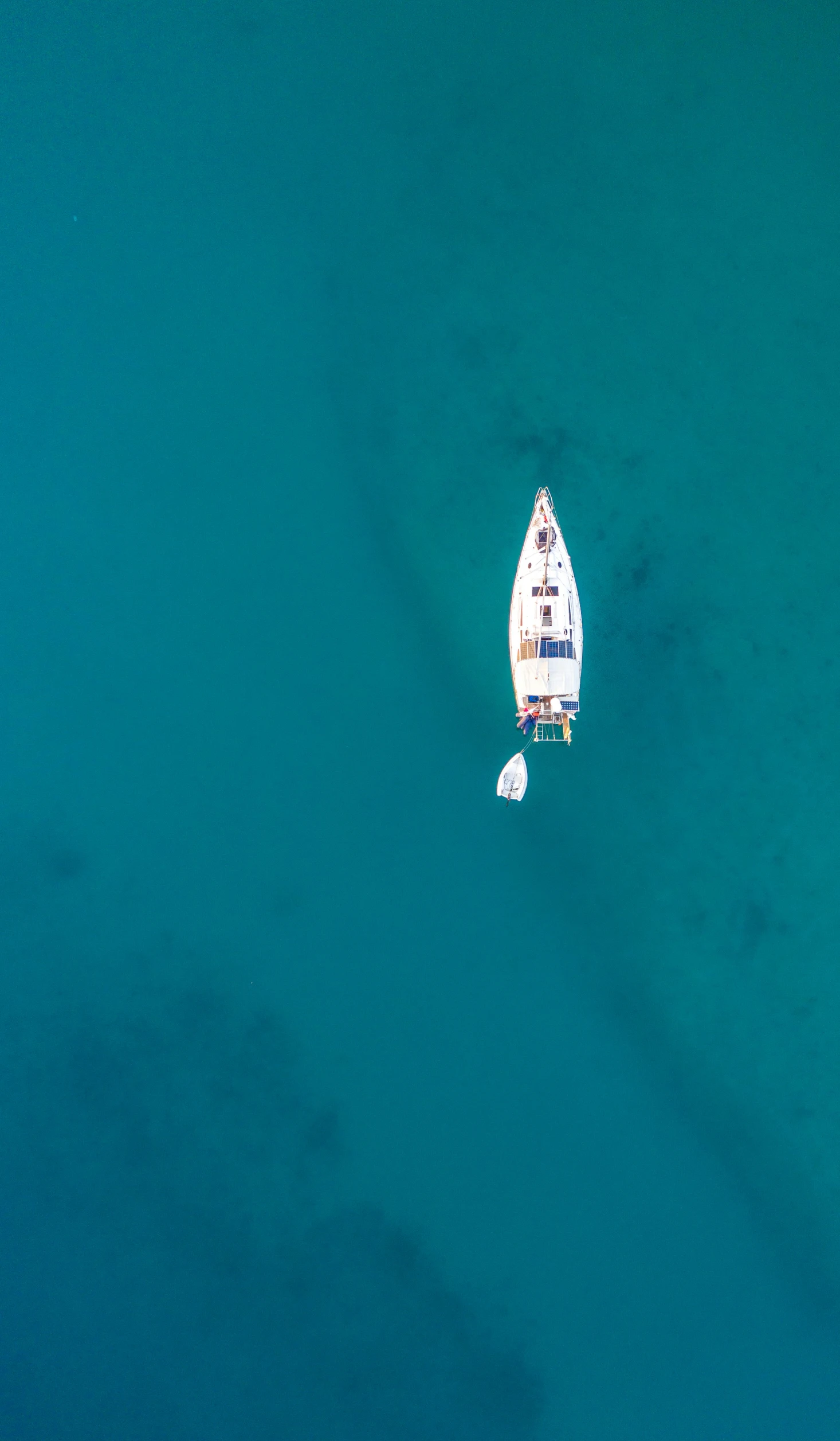 a couple of boats floating on top of a body of water, by Peter Churcher, pexels contest winner, minimalism, aerial view cinestill 800t 18mm, relaxing on a yacht at sea, lachlan bailey, thumbnail