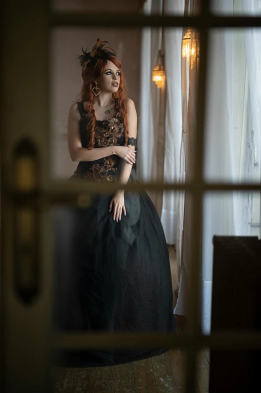 a woman in a black dress standing in front of a window, by Ivana Kobilca, pexels contest winner, renaissance, sullen old maid ( redhead, black metal rococo, steampunc, wearing an evening gown