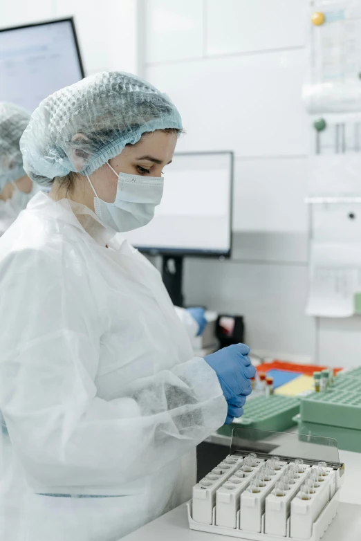 a group of people working in a lab, a picture, shutterstock, surgical supplies, low quality photo, thumbnail, female