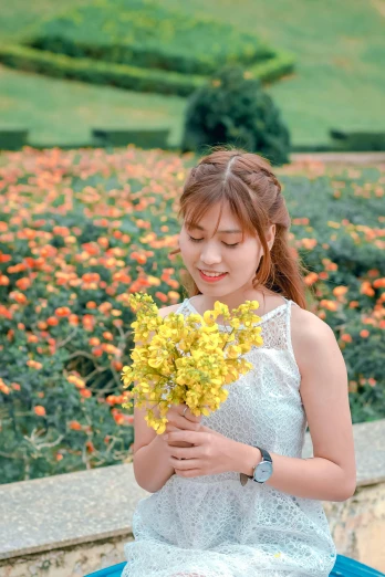 a woman sitting on a bench holding a bunch of flowers, by Tan Ting-pho, pexels contest winner, wearing yellow croptop, avatar image, sparkling, sleeveless