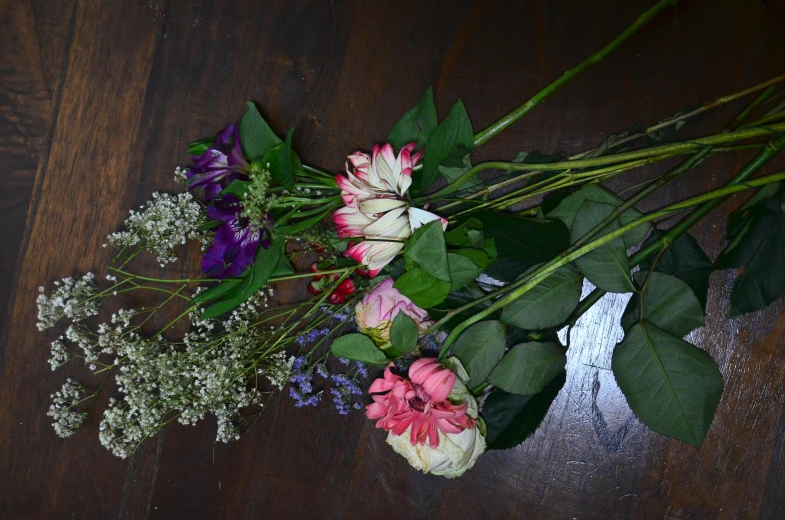 a bunch of flowers sitting on top of a wooden table, flattened, 3delight, artisanal art, unedited