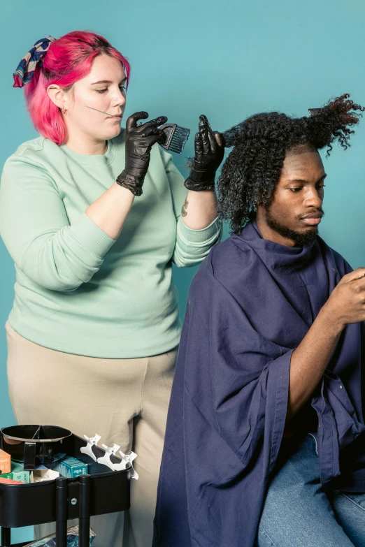 a woman getting her hair done by a hair stylist, an album cover, by Meredith Dillman, black man with afro hair, uncropped, non-binary, studio photo