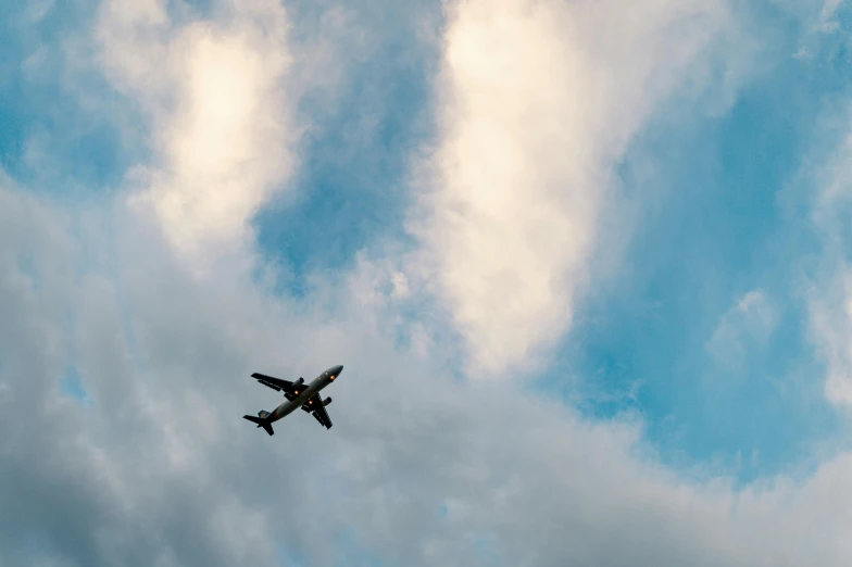 an airplane flying through a cloudy blue sky, by Carey Morris, pexels contest winner, thumbnail, slightly pixelated, festivals, a green