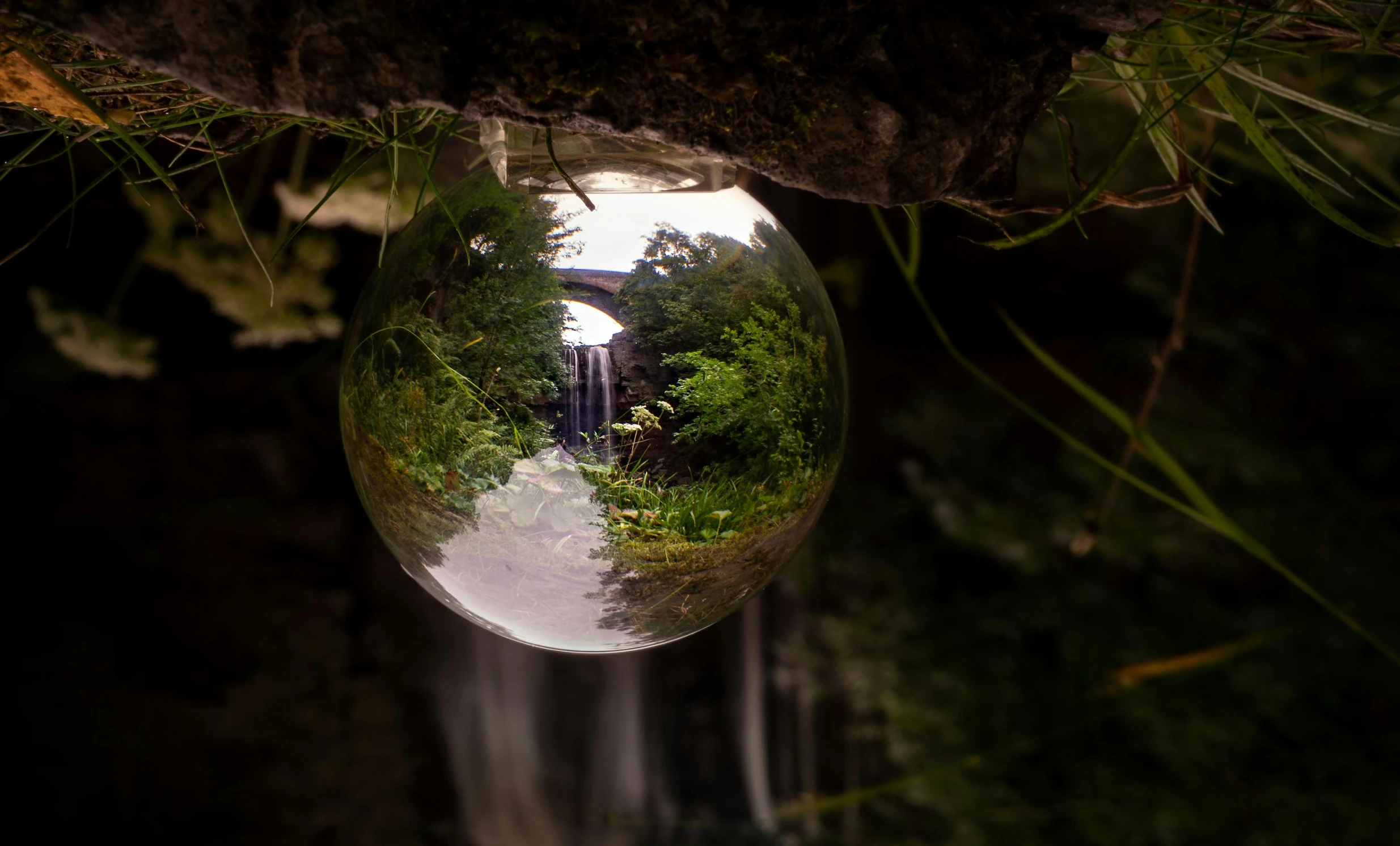 a reflection of a waterfall in a glass ball, inspired by Frederic Church, pexels contest winner, environmental art, today\'s featured photograph 4k, waterfall cave, planet overgrown, today's featured photograph 4 k