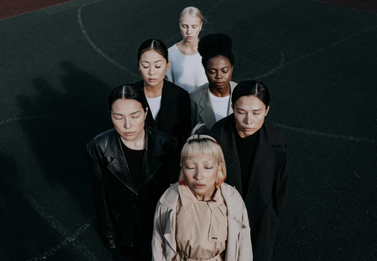 a group of people standing on top of a basketball court, an album cover, by Emma Andijewska, pexels contest winner, antipodeans, asian women, women's faces, a blond, ethnicity : japanese