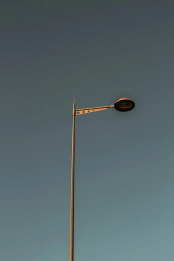 a street light with a blue sky in the background, by Jesper Knudsen, postminimalism, asleep, metallic light, brown, wide