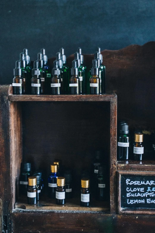 a bunch of bottles sitting on top of a wooden shelf, unsplash, renaissance, skincare, panel of black, shop front, bedhead