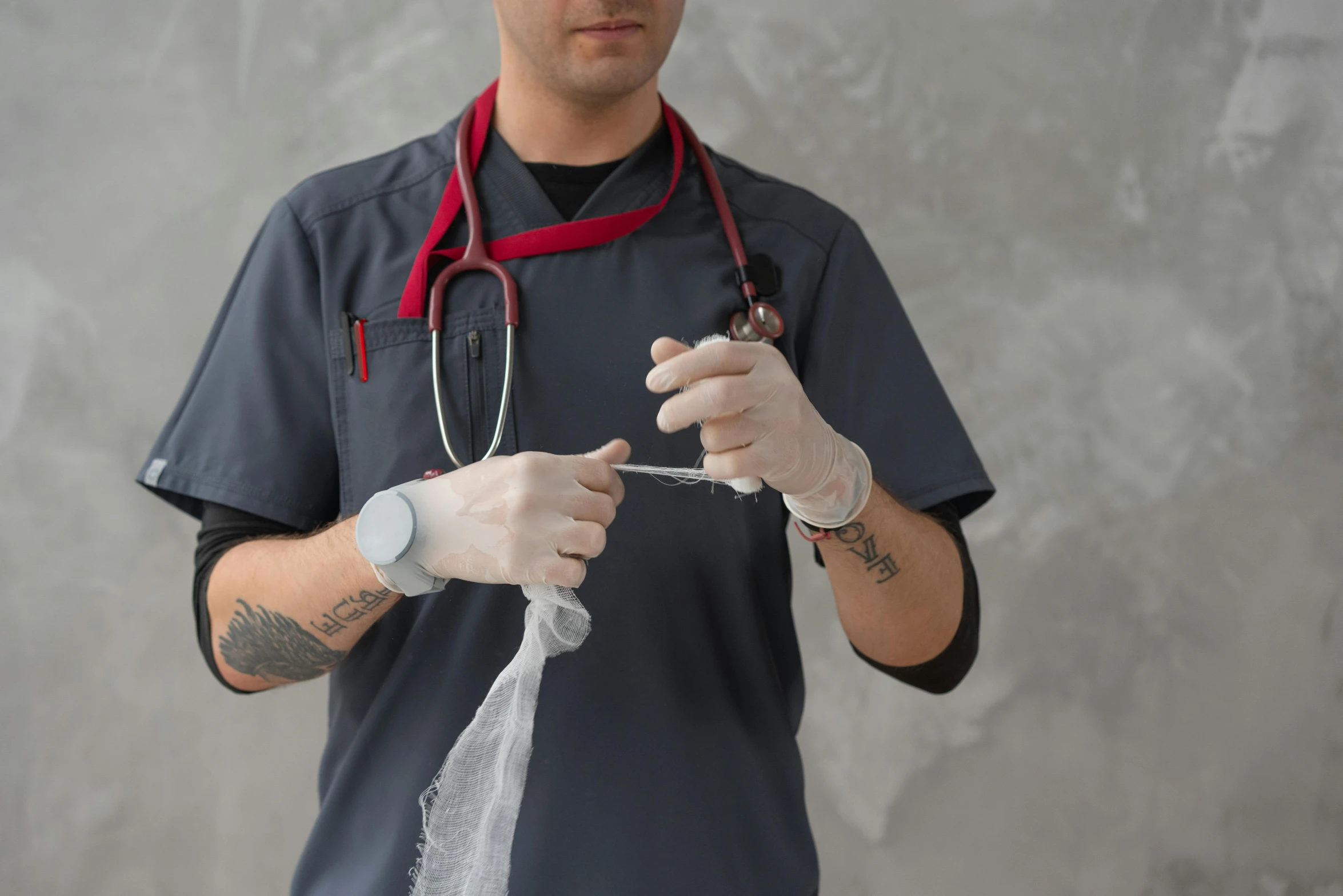 a man with a stethoscope in his hand, by Adam Marczyński, pexels contest winner, happening, surgical iv bag, on grey background, nurse scrubs, with wires and bandages