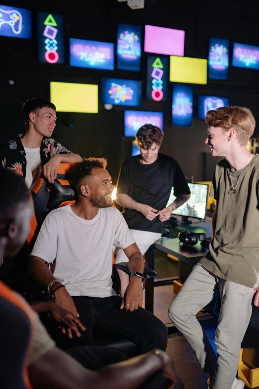 a group of young men playing a video game, liam brazier and nielly, backroom background, black teenage boy, camaraderie