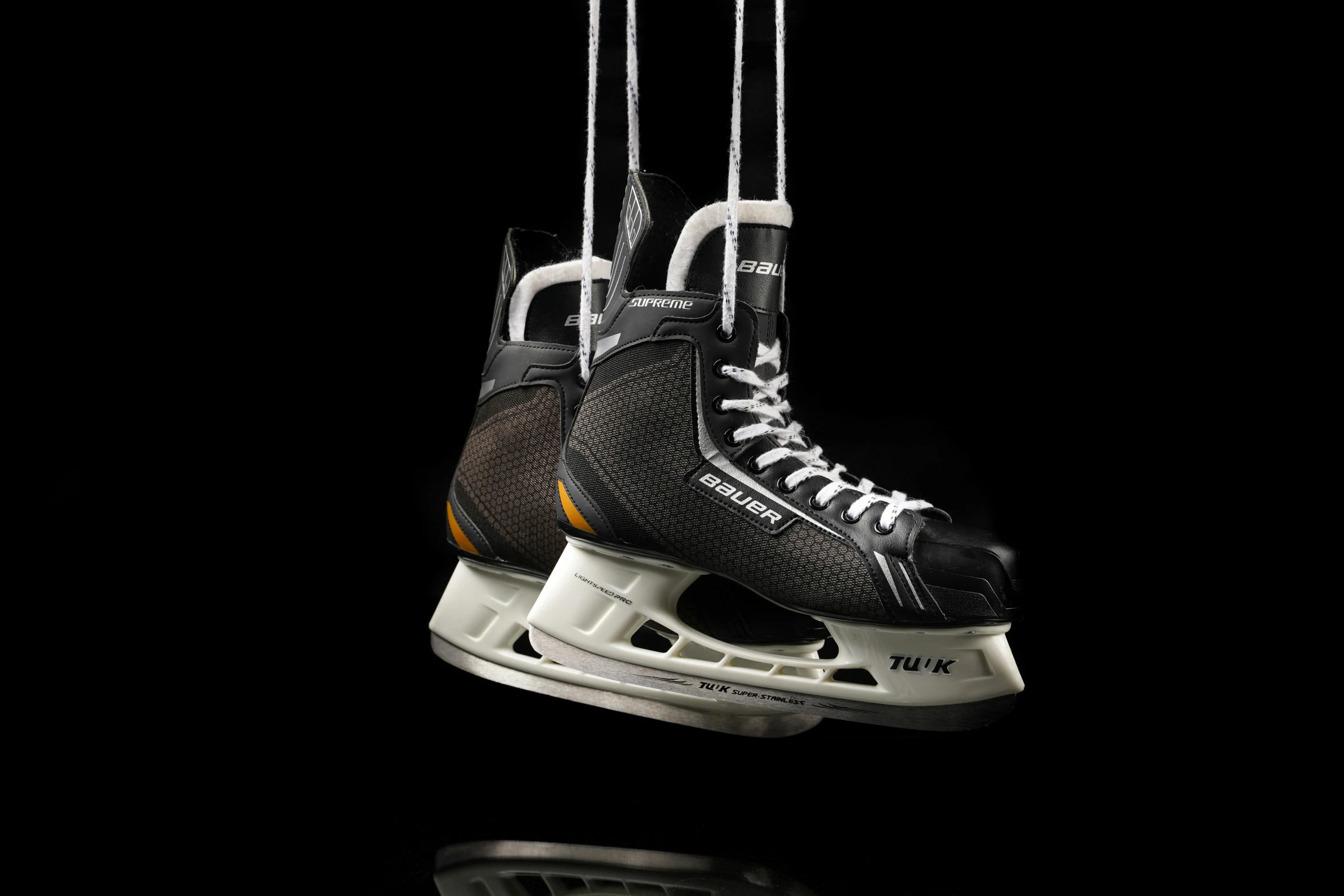 a pair of ice skates hanging from strings, a digital rendering, inspired by John Gibson, trending on zbrush central, high-speed sports photography, dramatic product lighting, portrait n - 9, teaser