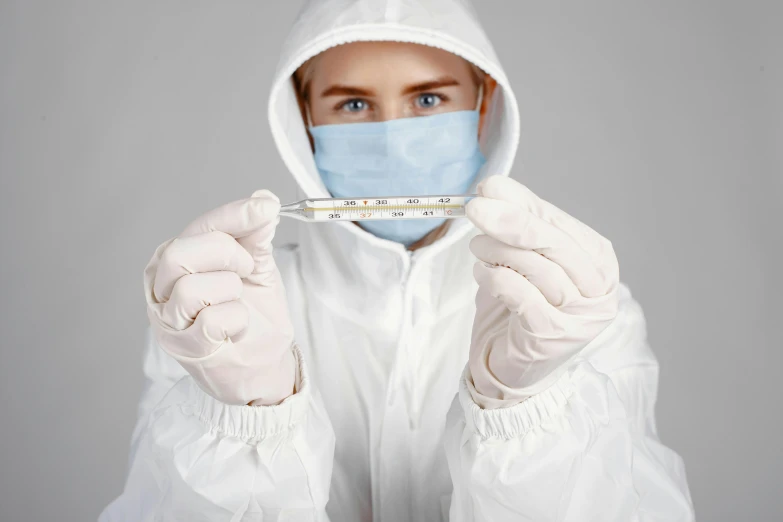 a man in a medical gown holding a thermometer, plasticien, in a hoodie, thumbnail, grey, synthetic