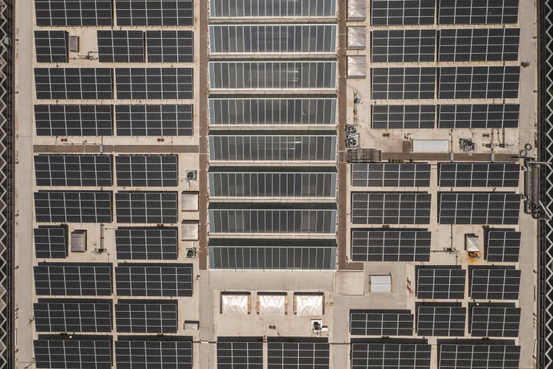 a building that has a bunch of solar panels on it, an album cover, unsplash, dji top down view, ignant, gray, panel