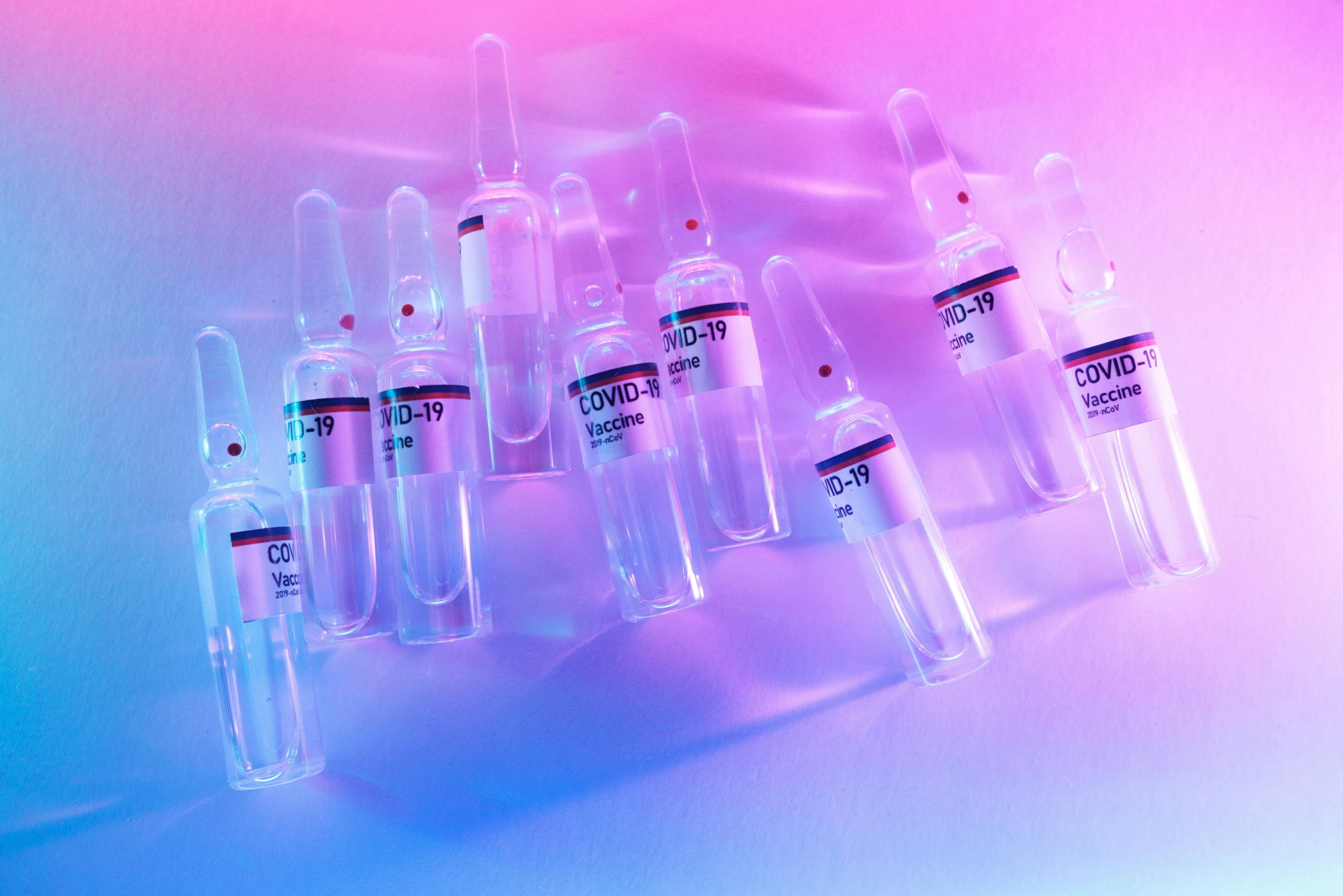 a group of vials sitting on top of a table, an album cover, trending on pexels, purple and pink and blue neons, syringe, skin care, pastel colourful 3 d