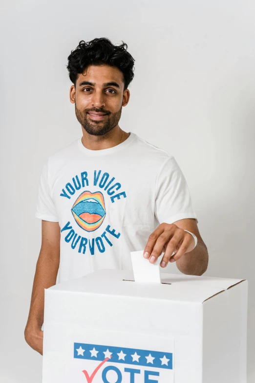 a man putting a vote in a voting box, by Jacob Toorenvliet, shutterstock contest winner, printed on a cream linen t-shirt, looking happy, 🚿🗝📝, ash thorp khyzyl saleem