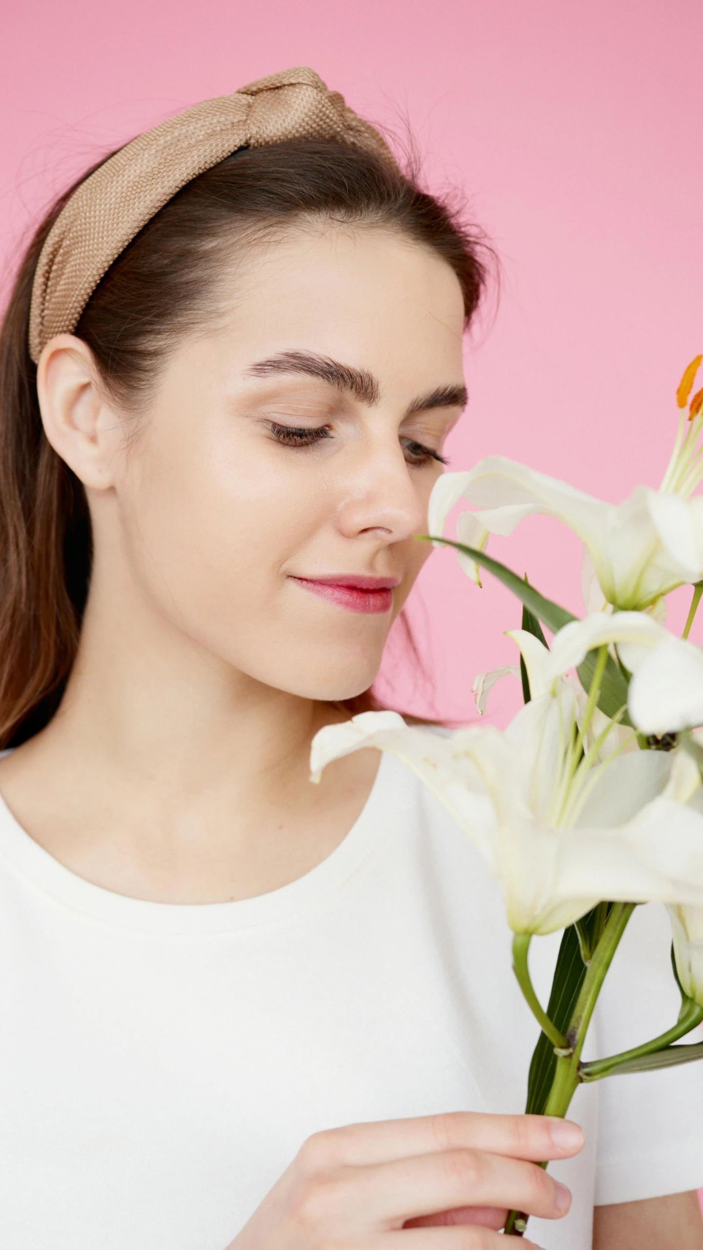 a woman holding a vase with flowers in it, perfect nose, white and pink, skincare, lily