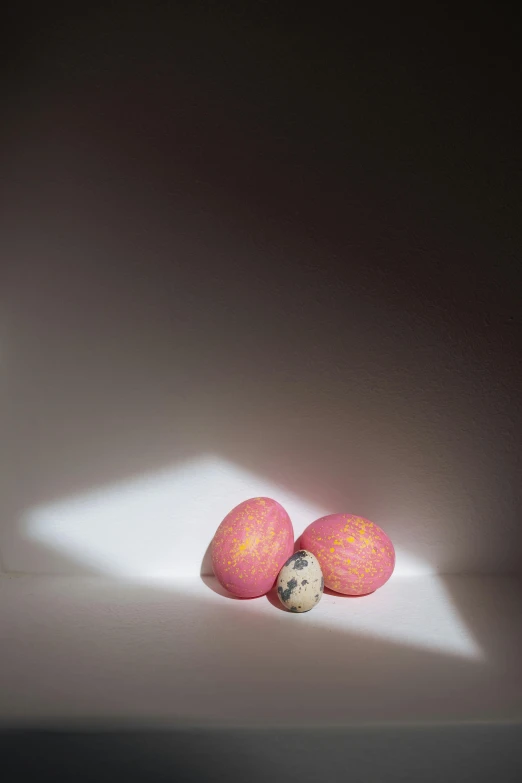 a couple of eggs sitting on top of a table, by Peter Alexander Hay, photorealism, pink, made of glowing wax and ceramic, suns, photograph taken in 2 0 2 0