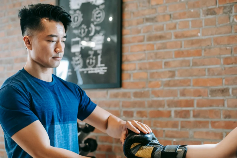 a man standing next to a woman in a gym, by Simon Gaon, elbow pads, avatar image, kintsugi, professional image